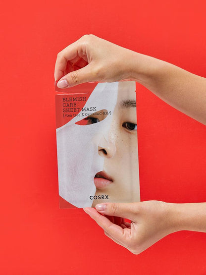 COSRX AC Collection Blemish Care Sheet Mask sachet held in hand for scale