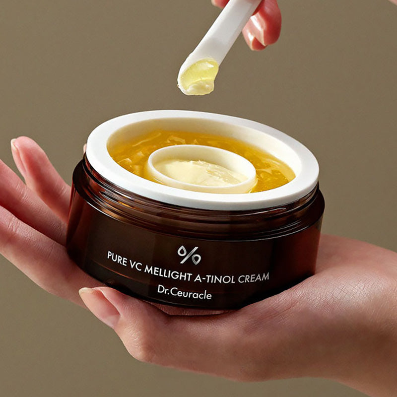 Open Dr.Ceuracle Pure VC Mellight A-Tinol Cream 70g jar held in hand with spatula